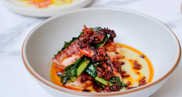 A plate of chargrilled octopus with fava bean puree and chicory and chorizo oil